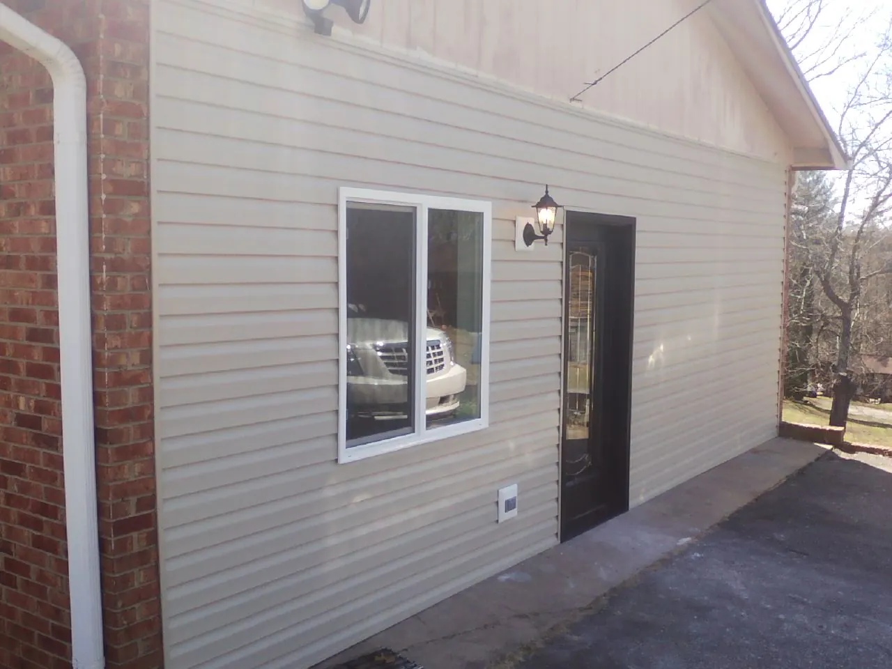 New vinyl siding and entry door on a room addition in Newnan